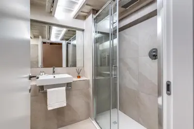 a bathroom with a sink and a shower at Appartamento centro storico BACCINAHOME in Rome