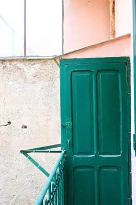 a green door on the side of a building at Casa Pesa 2 rooms 2 baths Rome center in Rome