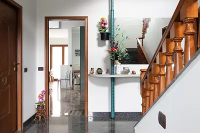 a hallway of a house with a staircase and a door at Castelbarco House B in Rome
