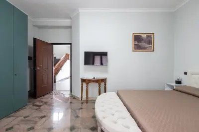 a bedroom with a bed and a table and a staircase at Castelbarco House B in Rome