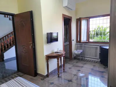 a room with a table and a television on a wall at Castelbarco House A in Rome
