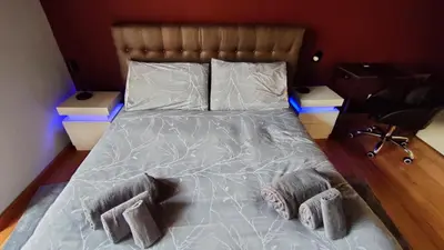 a large bed with two pillows on it in a bedroom at Auditorium Deluxe in Rome
