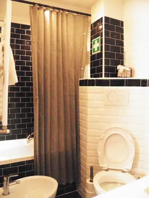 a bathroom with a shower curtain and a toilet at Auditorium Deluxe in Rome