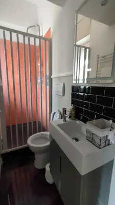 a bathroom with a sink and a toilet and a mirror at Auditorium Deluxe in Rome