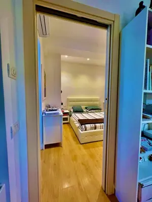 a view of a bedroom with a bed and a table at Auditorium luxury suite Roma in Rome
