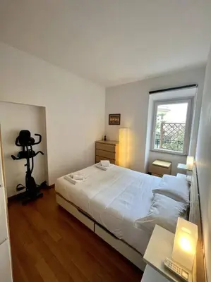 a bedroom with a white bed and a window at St. Peter Home Private Terrace in Rome