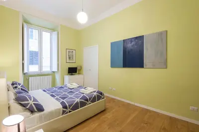a bedroom with a bed and a television on the wall at Luxury Three Bedrooms flat in Roma Center in Rome