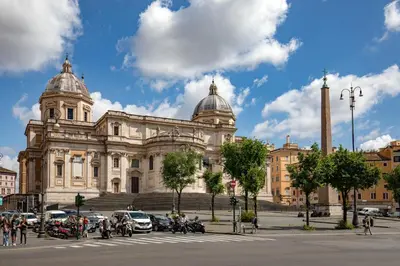 a large building with vehicles parked in front of it at Daplace - Hotel Gran Torino Suites in Rome