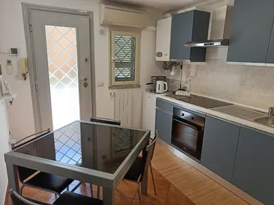 a kitchen with a table and some chairs in it at Suites in Rome in Rome