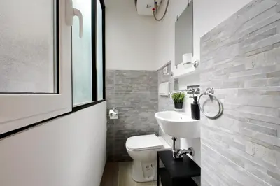 a bathroom with a white toilet and a sink at Katia Charme in Rome