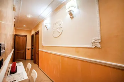 a hallway of a hospital with a table and chairs at Funny Holiday in Rome
