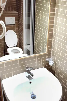 a bathroom with a sink and a toilet with a mirror at Funny Holiday in Rome