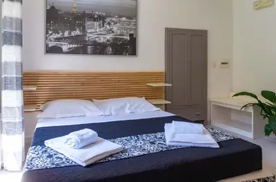 a bedroom with a bed with two towels on it at Le suite di Borgo in Rome