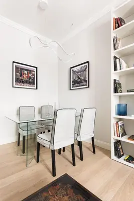 a dining room with a glass table and two chairs at Idyllia - Elegant central flat in Rome