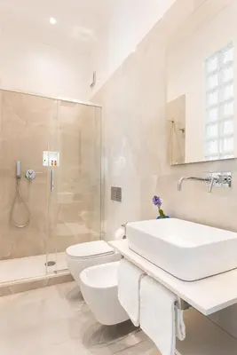 a bathroom with a sink and a toilet and a shower at Idyllia - Elegant central flat in Rome