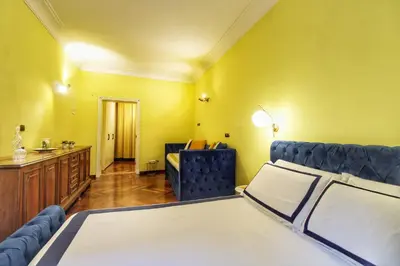 a room with a bed and a couch and a desk at Large and Charming Apartment in Trastevere by YourHost in Rome