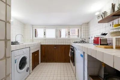 a kitchen with a washer and dryer in it at Rome As You Feel - Librari Penthouse with Terrace in Rome