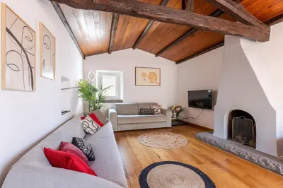 a living room with a couch and a fireplace at Rome As You Feel - Librari Penthouse with Terrace in Rome