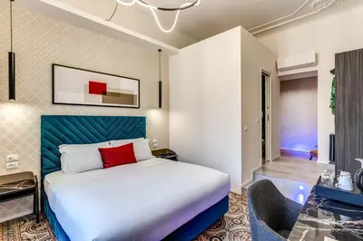 a hotel room with a bed and a chair at Arenula Suites in Rome