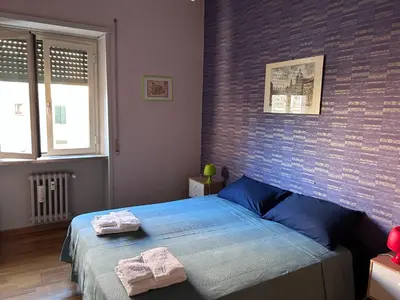 a bedroom with a bed with two towels on it at Un piacevole alloggio turistico in Rome