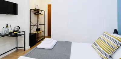 a bedroom with a white bed and a tv at Termini Suite Inn Rome in Rome