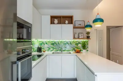 a kitchen with white cabinets and a sink at Magnolia terrace at Vatican Museum in Rome