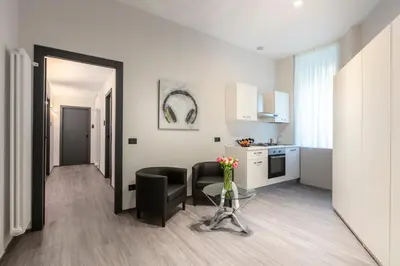 a kitchen and a living room with a table and chairs at Residenza Sacconi by Hili in Rome
