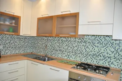 a kitchen with white cabinets and a sink at Mary's House in Rome