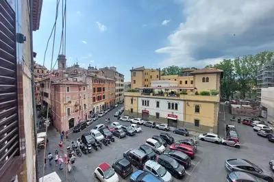 a city with cars parked in a parking lot at suity I cozy coronari apartment in Rome