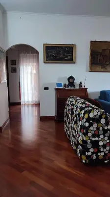 a living room with a couch and a wooden floor at Montagnola House in Rome
