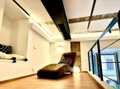 a living room with a chair and a window at Buonarroti Art Home - Luxury and Art in Rome in Rome