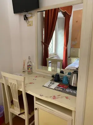a small kitchen with a table and a mirror at Residenza in Rome