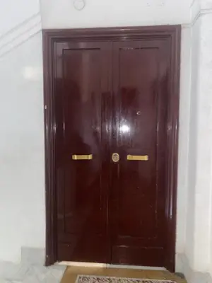a large wooden door in a white room at Residenza in Rome