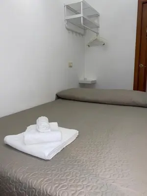 a bed with two beds with white towels on it at Residenza in Rome