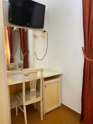 a room with a desk with a tv on the wall at Residenza in Rome