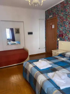 a hotel room with a bed and a mirror at Residenza in Rome