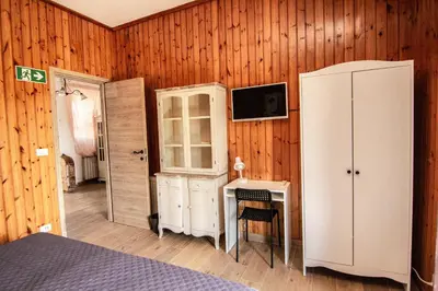 a bedroom with a bed and a cabinet and a desk at Yourquadrarooms B&b in Rome