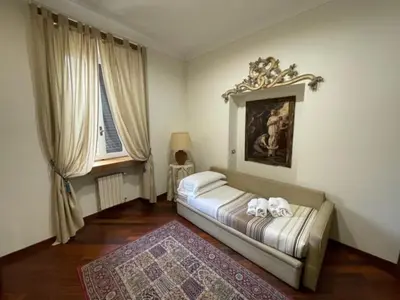 a living room with a bed and a rug at Colosseum Street in Rome
