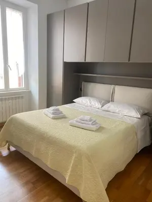 a bedroom with a large mirror on the wall at Leonard Vatican House in Rome