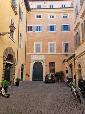 a car parked in front of a large building at coronari apartments 2 in Rome