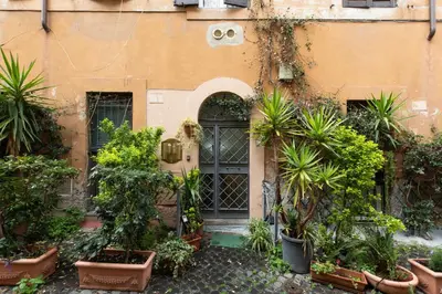 a building with plants in front of a door at GuestHost - Comfy Studio x2 - Trastevere District! in Rome