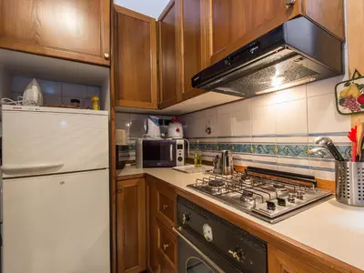a kitchen with a stove and a white refrigerator at Apartment Navona by Interhome in Rome