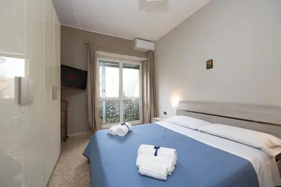 a bedroom with a blue bed with towels on it at Big Apartment Rome Air Conditioning WIFI Netflix 90 MQ in Rome