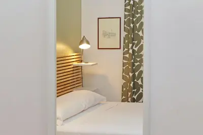 a small bedroom with a bed and a window at Luxury Vatican White House in Rome
