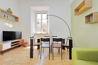 a dining room with a table and chairs and a television at Luxury Vatican White House in Rome