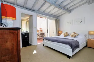 a bedroom with a bed and a television in it at Monti Charme - My Extra Home in Rome