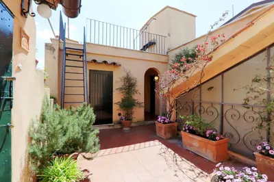 a courtyard of a house with potted plants at Monti Charme - My Extra Home in Rome