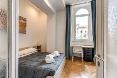 a bedroom with a bed and a window and a desk at V E N E R E Apartments in Rome