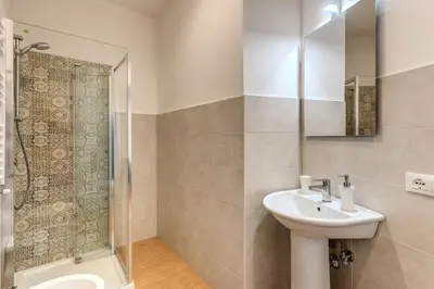 a bathroom with a sink and a shower at V E N E R E Apartments in Rome