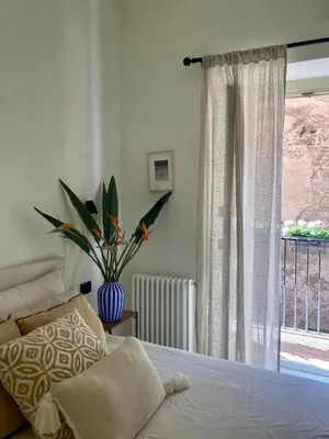 two black vases sitting on a wooden table with sticks at Apartment in the heart of Rome in Rome